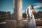 Ethereal, divine bride with shiny dress and groom standing near