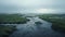 Ethereal River Running Through Grass: Atmospheric Marsh Photo