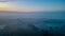 Ethereal Sunrise Over Mist Enshrouded Farmland