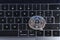 Ethereum cryptocurrency crypto currency. Silver Ethereum coin with gold Ethereum symbol on a laptop keyboard next to the Enter