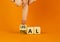 Ethical or legal symbol. Businessman turns wooden cubes and changes the word Ethical to Legal on a beautiful orange table orange