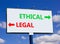 Ethical or legal symbol. Concept word Ethical or Legal on beautiful billboard with two arrows. Beautiful blue sky with clouds