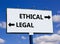 Ethical or legal symbol. Concept word Ethical or Legal on beautiful billboard with two arrows. Beautiful blue sky with clouds