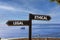 Ethical or legal symbol. Concept word Ethical or Legal on beautiful signpost with two arrows. Beautiful blue sea sky with clouds