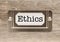 Ethics Metal File Cabinet Label Frame on Wood