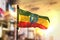 Ethiopia Flag Against City Blurred Background At Sunrise Backlight