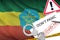 Ethiopia flag and police handcuffs with inscription Don`t panic on white paper. Coronavirus or 2019-nCov virus concept