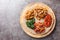 Ethiopian Injera topped with meat, vegetables, greens close up on the wooden board. Horizontal top view