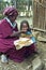 Ethiopian woman gives daughter injera to eat