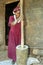 Ethiopian woman is pounding grain into flour