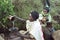 Ethiopian women fetch water from natural well