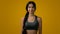 Ethnic 20s woman Indian sport lady smiling multiracial strong slender girl sports trainer yoga runner posing in yellow