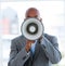 Ethnic businessman yelling through a megaphone