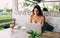 Ethnic businesswoman working on laptop on cafeteria terrace