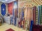 Ethnic carpet, ornamental folk bags, many ornate pillows with embroidery in asian shop, store. Asian market, trade fair in