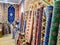 Ethnic carpet, ornamental folk bags, many ornate pillows with embroidery in asian shop, store. Asian market, trade fair