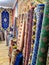 Ethnic carpet, ornamental folk bags, many ornate pillows with embroidery in asian shop, store. Asian market, trade fair