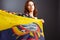 Ethnic Ecuadorian lady with the waving Ecuador flag isolated on gray background