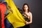 Ethnic Ecuadorian lady with the waving Ecuador flag isolated on gray background