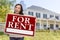 Ethnic Female Holding For Rent Sign In Front of House