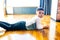 ethnic hispanic curly son sitting on floor warm brown clean safety parquet at home