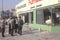 Ethnic men observing furniture store looted during 1992 riots, South Central Los Angeles, California