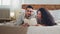 Ethnic multiracial multiethnic couple woman lady and bearded man lie together on bed read book. Married couple reading