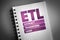 ETL - Extract Transform Load acronym on notepad, technology concept background