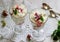 Eton mess, traditional English dessert with gooseberry, whipped cream and meringue on a light background. Rustic style.