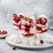 Eton mess, traditional english dessert, meringues, whipped cream, berry sauce and fresh raspberry in  glass