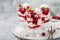 Eton mess, traditional english dessert, meringues, whipped cream, berry sauce and fresh raspberry in  glass