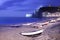 Etretat village, bay beach and boats on foggy night. Normandy, France.