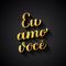 Eu Amo Voce gold calligraphy hand lettering on black background. I Love You in Brazilian Portuguese. Valentines day