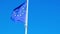 EU European flag poole blowing in the wind on a bright sunny summers day. Frayed European Union flag is fluttered by