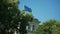 EU Flag Moving In The Wind Behind Trees In Berlin In Summer