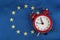 EU flag and vintage alarm clock. Close up. Time to join the EU