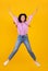 Euphoria concept. Full length portrait on positive armenian woman jumping and fooling on yellow background, crop