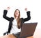 Euphoric businesswoman in an office with a laptop