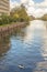 Eurasian Coot stands on a piece of floating styrofoam plastic litter in a canal in Amsterdam