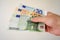 Euro bank-notes in white man hand. Pay bills with money. Currency concept. European currency