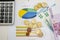 Euro banknotes, calculator and coins on a business graph. Business concept. View from above.