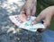 Euro banknotes close-up in the hands of an adult woman. Poverty and wealth