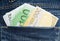 Euro banknotes in hip-pocket of jeans