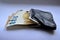 Euro banknotes stick out of a black wallet