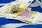 Euro bills on the Greek flag with the shell on top