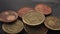 Euro cents coins on old black crumpled wrapping paper close-up