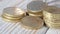 Euro cents are laid out in stacks on a wooden background. Macro view