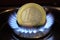 Euro coin burning in gas flame