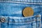 Euro coin with a denomination of 10 euro cent in the pocket of old worn blue denim jeans