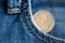 Euro coin with a denomination of two euro in the pocket of vintage worn blue denim jeans